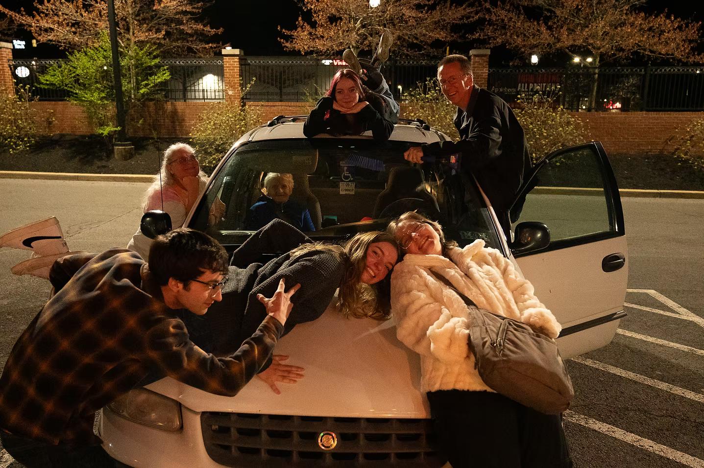 Willow posing with all of his family on their car.
